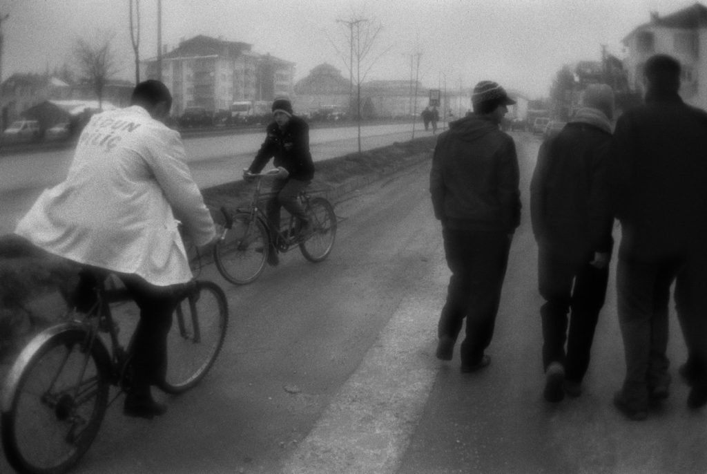 Cyclists and teenagers near the road in Düzce town. Turkey, 07