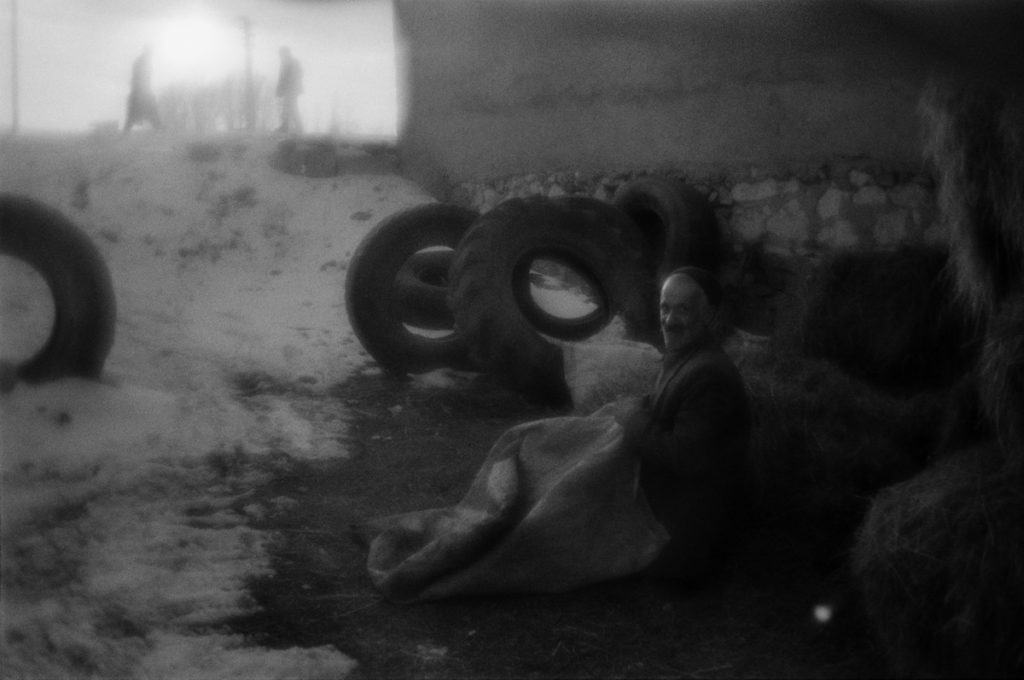 A man fills sacks with hay. Town of  Aşkale near Erzurum. Turke