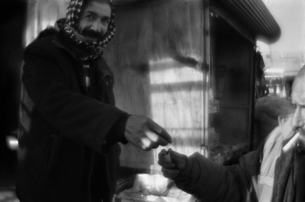 Man shares cigarets with another at the marketplace in Diyarbakï