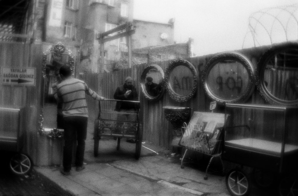 Mirrors hanged for the sale at the fence of the metro bridge con